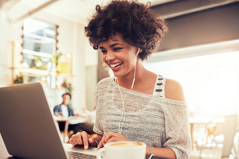 Image,Of,Happy,Woman,Using,Laptop,While,Sitting,At,Cafe.